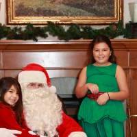 Two sisters sitting with Santa.